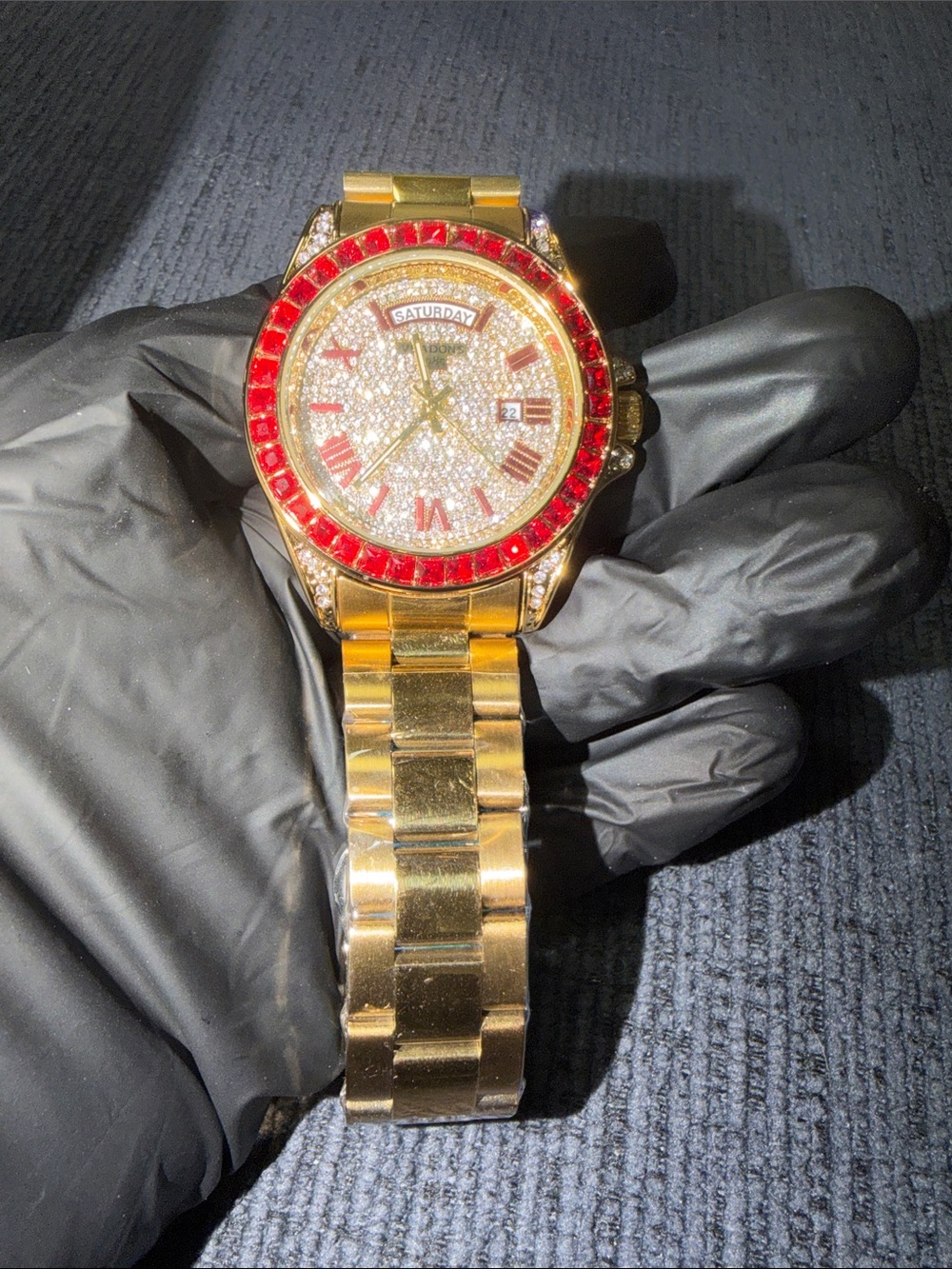 Gold Tone Men’s Watch with Red Crystal Bezel